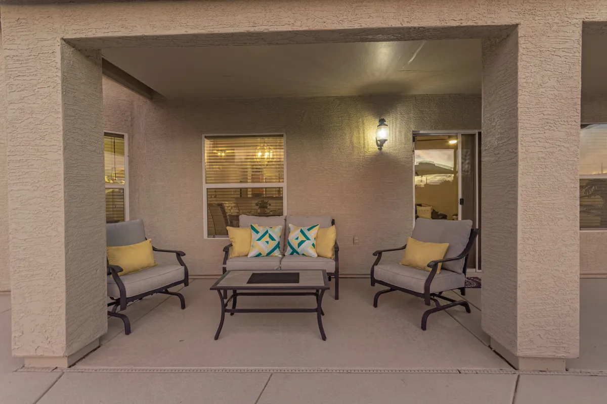 A cozy exterior seating area with comfortable chairs, colorful cushions, and inviting outdoor lighting. The space is designed for relaxing, socializing, and soaking up the outdoors, making it ideal for families—and their pets—to unwind after a day of adventure.