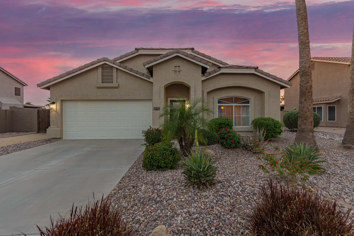 A welcoming front entrance with a landscaped yard and visible garage, suggesting a comfortable and accessible home base for commuting or exploring. The well-maintained entry hints at a family-friendly environment and the ease of coming and going for daily excursions.